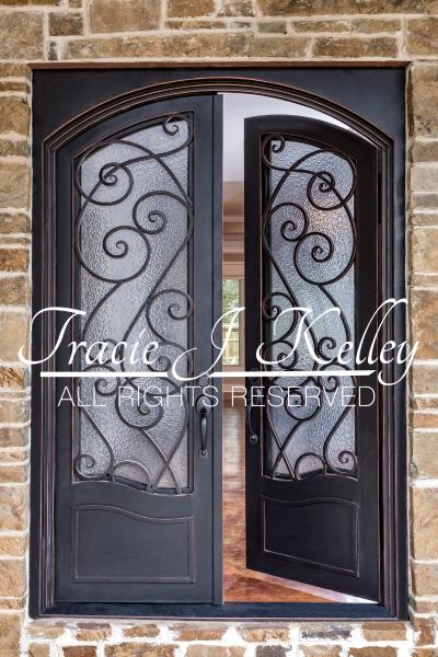 This beautiful front entrance features stand out doors to set this home apart that Tracie J. Kelley designed.